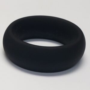 Wide Silicone Donut Ring Black 1.5 inches from Spartacus. Embrace the world of enhanced pleasure with the Wide Silicone C-Ring. Designed to be worn on the penis