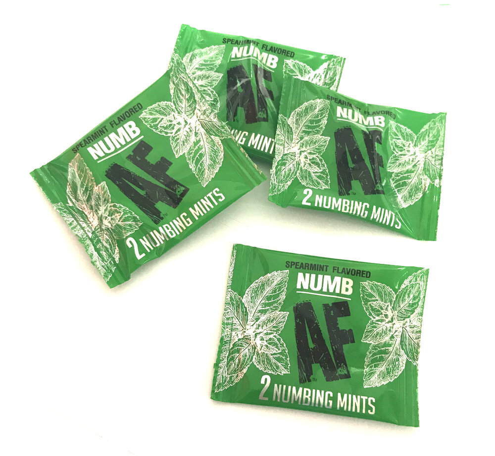 Numb AF Numbing Mints from Little Genie. Point of purchase display. 100 pieces with a fishbowl display. For her and him. Spearmint flavor. Fishbowl display contains 100 Pieces. Active ingredients: Lidocaine 5%. Inactive ingredients: Sorbitol