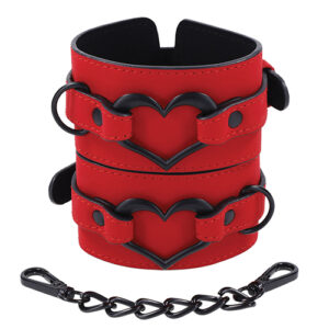 Sex and Mischief Amor Handcuffs from Sportsheets. Embrace the seductive allure and indulge in every electrifyingly moment with the Amor Handcuffs. Feel the smooth vegan leather adorn your wrists in a stunning red finish with a dazzling black heart accent